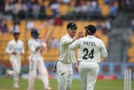 Glenn Phillips and Ajaz Patel of New Zealand celebrate the wicket of Ravindra Jadeja of India during day two of the First Test match between India and New Zealand at M. Chinnaswamy Stadium on October 17, 2024, in Bengaluru, India.